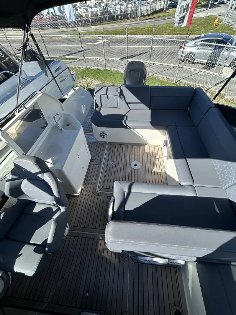 Slide: The Image of 2022 Parker Poland 850 Voyager boat interior with gray seating and wooden flooring. - 21