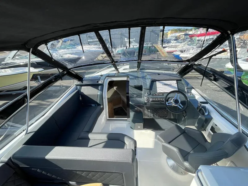 Slide: The Image of Interior view of 2022 Parker Poland 850 Voyager boat, featuring sleek seating and modern controls. - 3