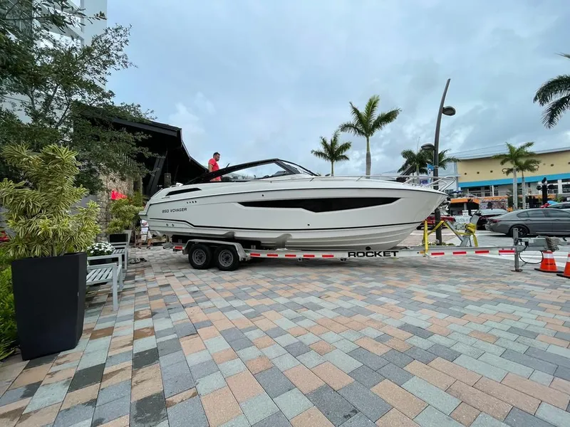 Slide: The Image of Parker Poland 850 Voyager 2022 boat on trailer in a tropical setting. - 4
