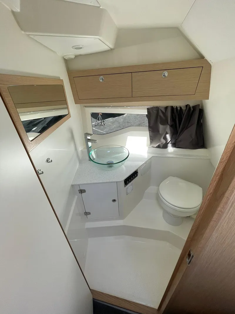 Slide: The Image of 2022 Parker Poland 850 Voyager boat bathroom with modern fixtures and compact design. - 7