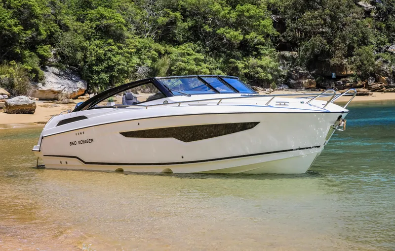 Slide: The Image of 2022 Parker Poland 850 Voyager boat in a serene, tropical beach setting. - 8