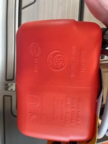 Slide: The Image of Red plastic component with embossed safety markings, Veer V13, 2023 model. - 13
