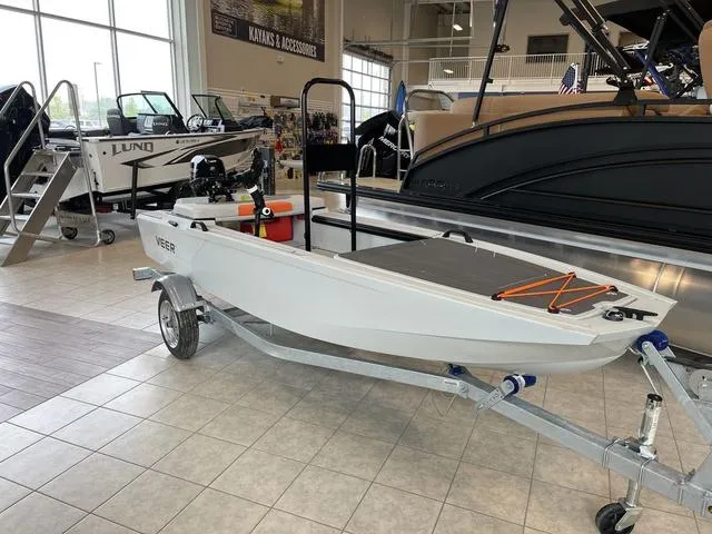 Slide: The Image of 2023 Veer V13 boat on display in showroom with other boats. - 3