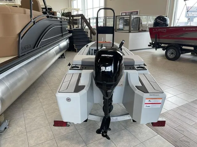 Slide: The Image of 2023 Veer V13 boat with Mercury 9.9 engine displayed indoors. - 5