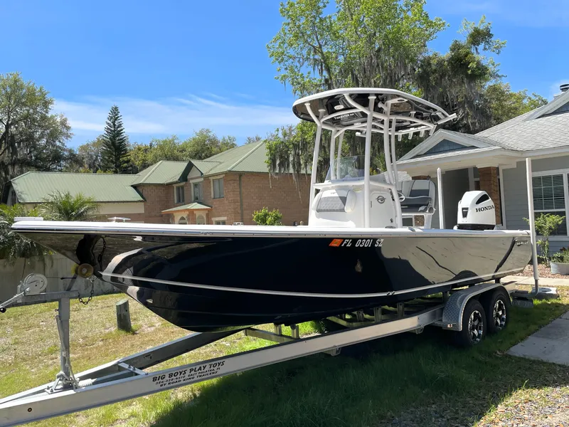 Slide: The Image of 2020 Tidewater 2300 Carolina Bay boat on trailer, parked in residential area. - 1