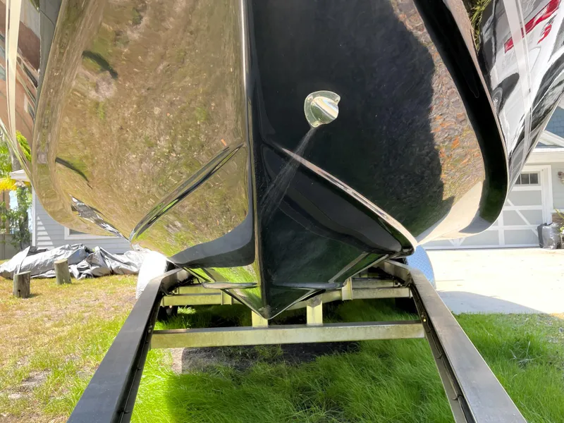 Slide: The Image of 2020 Tidewater 2300 Carolina Bay boat on trailer, viewed from below, showcasing hull design. - 10