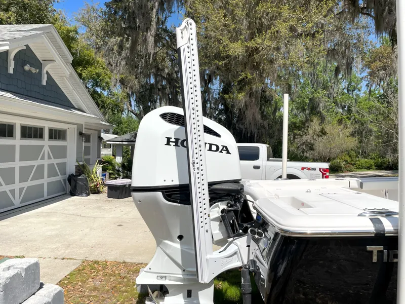 Slide: The Image of 2020 Tidewater 2300 Carolina Bay boat with Honda outboard motor in driveway. - 14