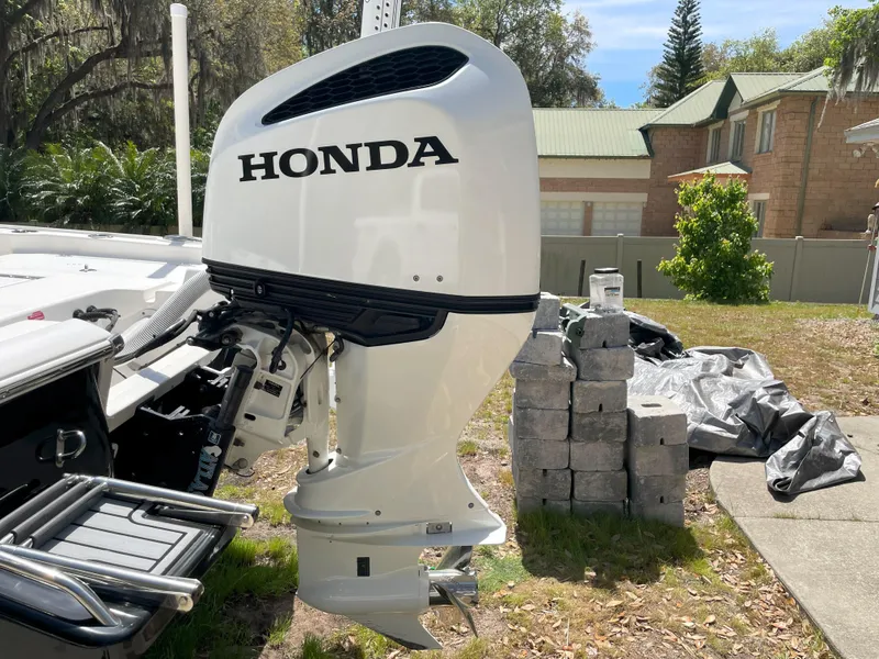 Slide: The Image of 2020 Tidewater 2300 Carolina Bay with Honda outboard motor in a residential setting. - 15