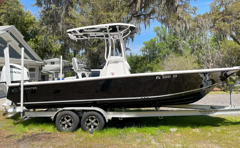 Slide: The Image of 2020 Tidewater 2300 Carolina Bay boat on trailer, parked outdoors. - 2