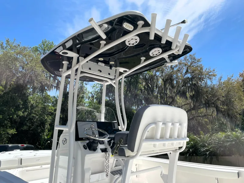 Slide: The Image of 2020 Tidewater 2300 Carolina Bay boat with T-top and console, set against a scenic backdrop. - 20