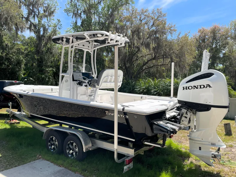 Slide: The Image of 2020 Tidewater 2300 Carolina Bay boat with Honda outboard motor on a trailer, parked outdoors. - 3