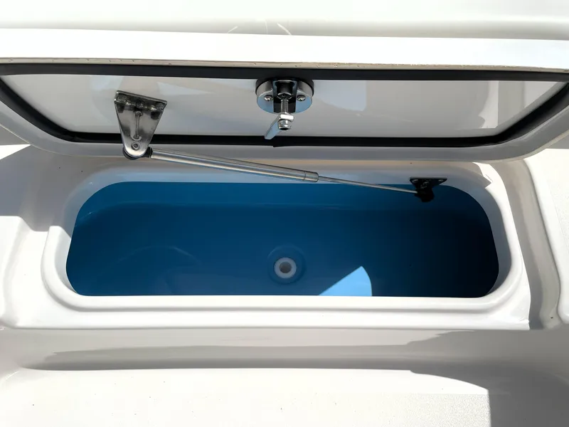 Slide: The Image of 2020 Tidewater 2300 Carolina Bay boat storage compartment with open lid, showcasing interior space. - 31