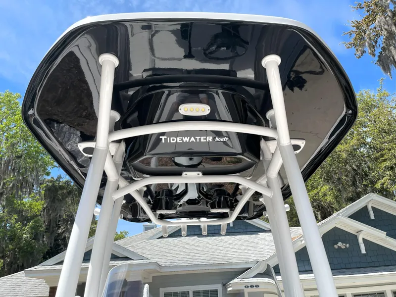 Slide: The Image of 2020 Tidewater 2300 Carolina Bay boat with T-top, viewed from below against a clear sky. - 34