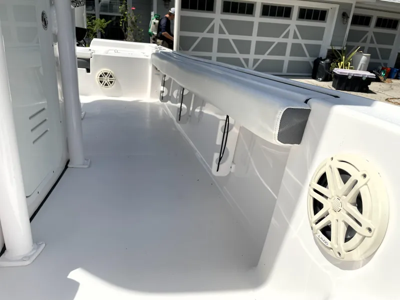 Slide: The Image of 2020 Tidewater 2300 Carolina Bay boat interior with white deck and speaker. - 37