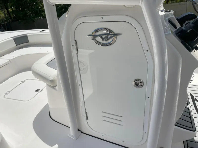 Slide: The Image of 2020 Tidewater 2300 Carolina Bay boat console with storage compartment and seating area. - 38