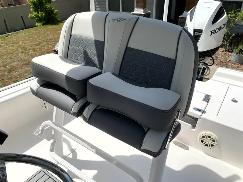 Slide: The Image of 2020 Tidewater 2300 Carolina Bay boat seats with Honda outboard motor in background. - 44