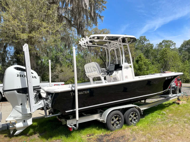Slide: The Image of 2020 Tidewater 2300 Carolina Bay boat on trailer with Honda engine, parked outdoors. - 5