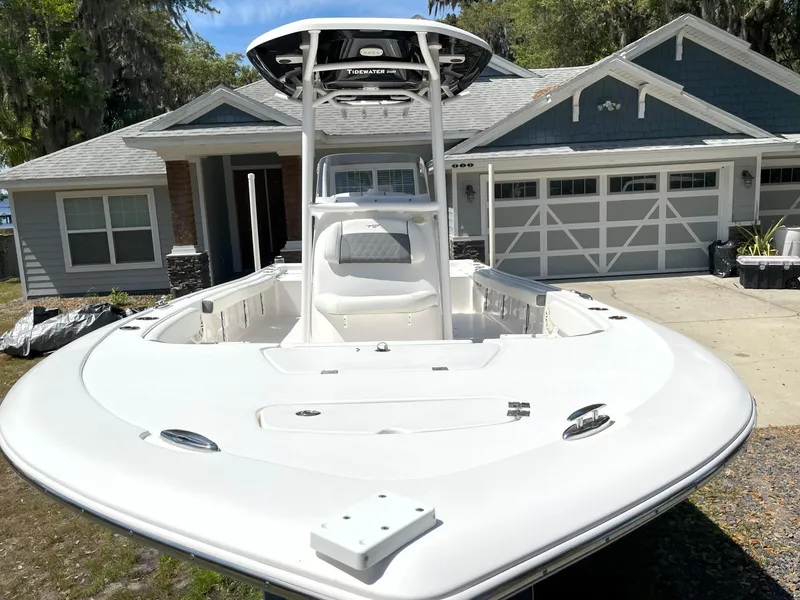 Slide: The Image of 2020 Tidewater 2300 Carolina Bay boat parked in front of a house. - 6