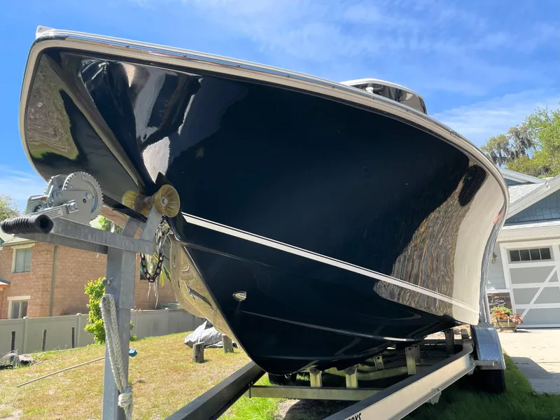 Slide: The Image of 2020 Tidewater 2300 Carolina Bay boat on trailer, parked outdoors under blue sky. - 9