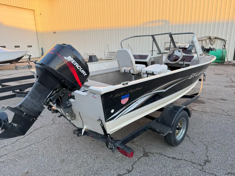 Slide: The Image of 2004 Sylvan 1600 Explorer DC boat with Mercury outboard motor on trailer. - 3
