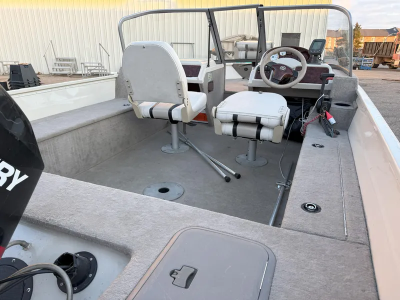 Slide: The Image of 2004 Sylvan 1600 Explorer DC boat interior with steering wheel and seating. - 6