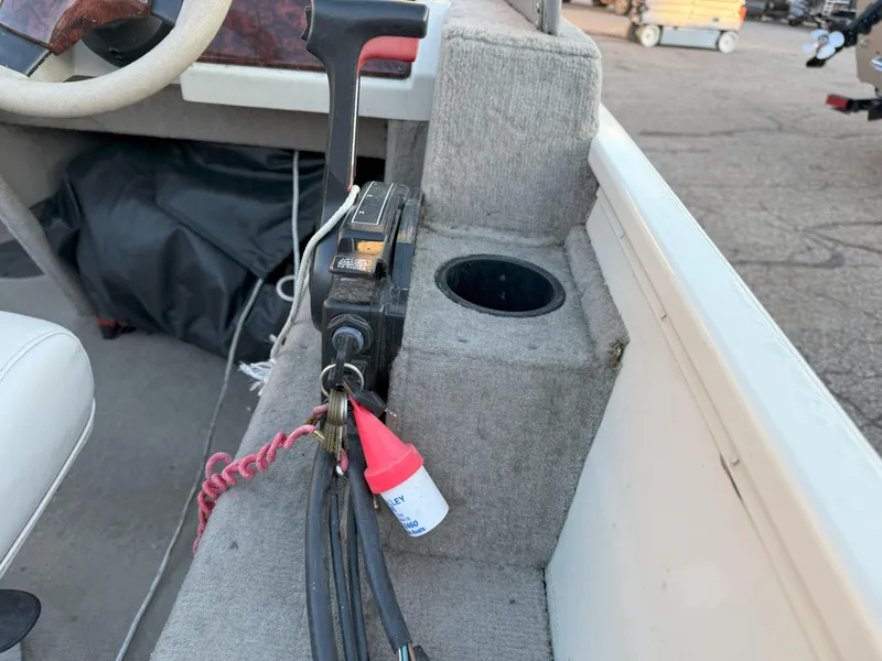 Slide: The Image of Interior of 2004 Sylvan 1600 Explorer DC boat with control panel and cup holder. - 8