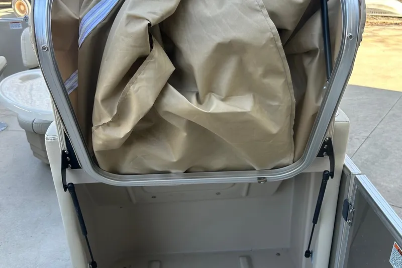 Slide: The Image of 2019 Sylvan 8520 Mirage F-n-C storage compartment with beige cover. - 11