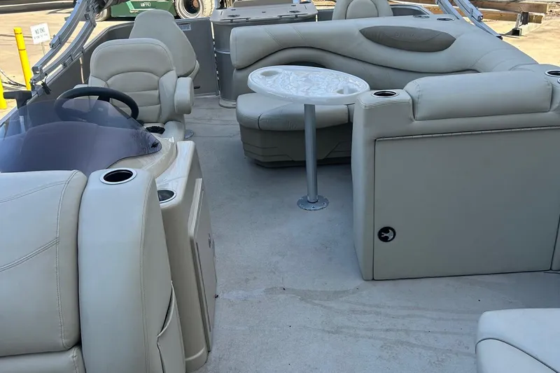 Slide: The Image of Luxurious interior of 2019 Sylvan 8520 Mirage F-n-C pontoon boat with plush seating and table. - 12
