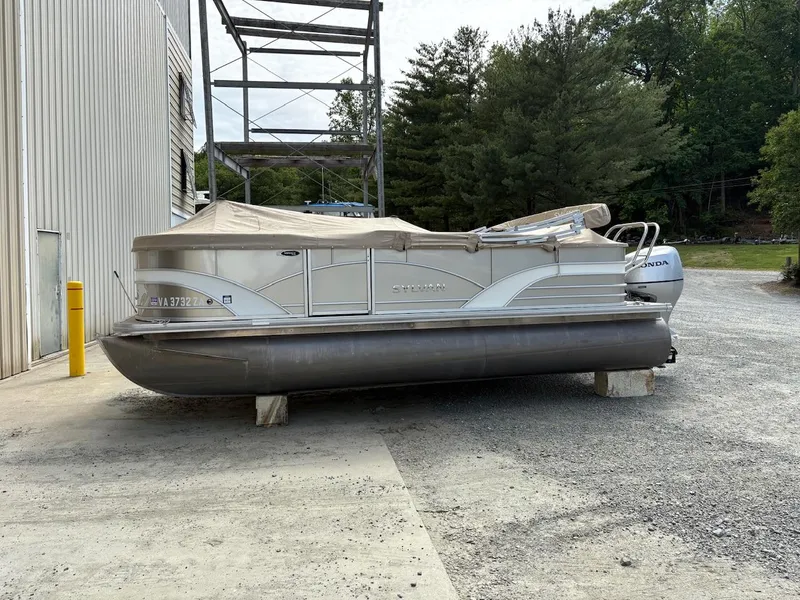 Slide: The Image of 2019 Sylvan 8520 Mirage F-n-C pontoon boat parked outdoors, covered, near a building. - 14