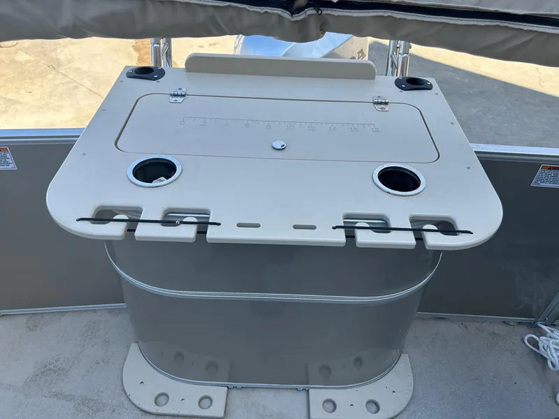 Slide: The Image of 2019 Sylvan 8520 Mirage F-n-C boat console with cup holders and storage compartment. - 3