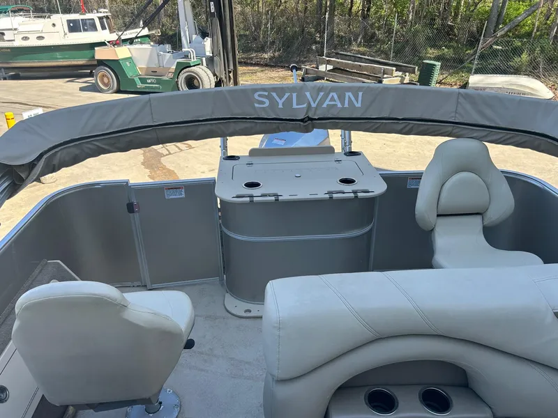 Slide: The Image of 2019 Sylvan 8520 Mirage F-n-C pontoon boat interior with seating and console. - 6