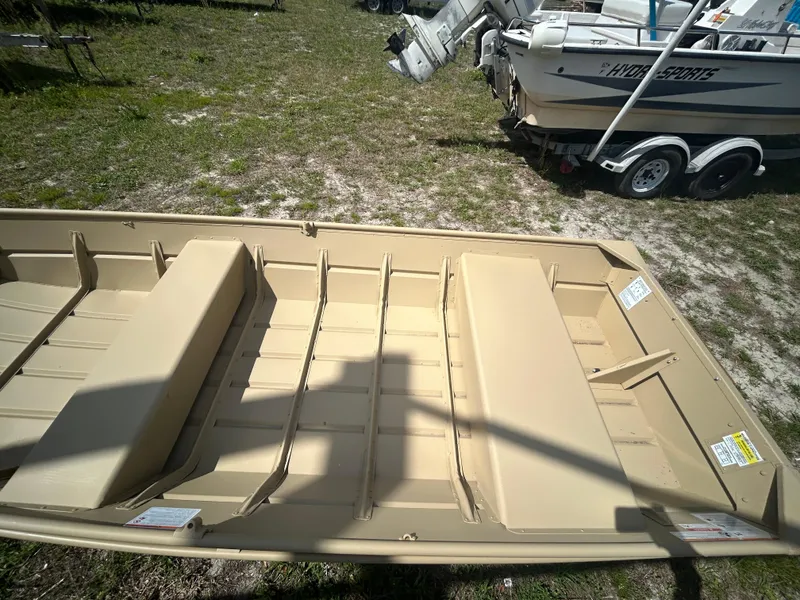Slide: The Image of 2025 Crestliner CR1436L boat on grass, near other boats and trailers. - 11
