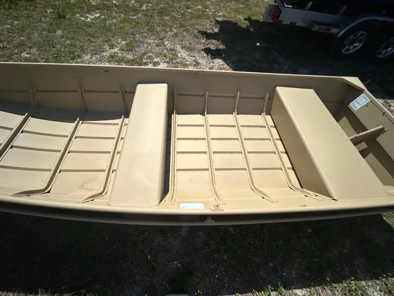 Slide: The Image of 2025 Crestliner CR1436L boat, beige interior, parked on grass, viewed from above. - 5