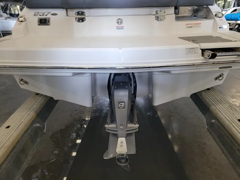 Slide: The Image of Rear view of a 2019 Chaparral 237 SSX boat on a trailer. - 13