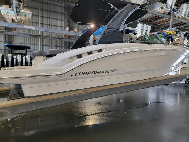 Slide: The Image of 2019 Chaparral 237 SSX boat in showroom, side view. - 2