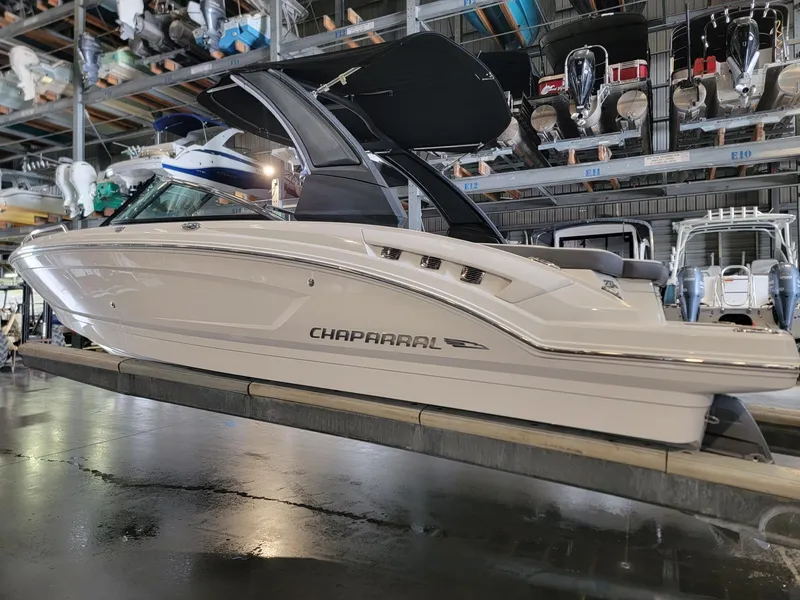 Slide: The Image of 2019 Chaparral 237 SSX boat in storage, side view, sleek design. - 4