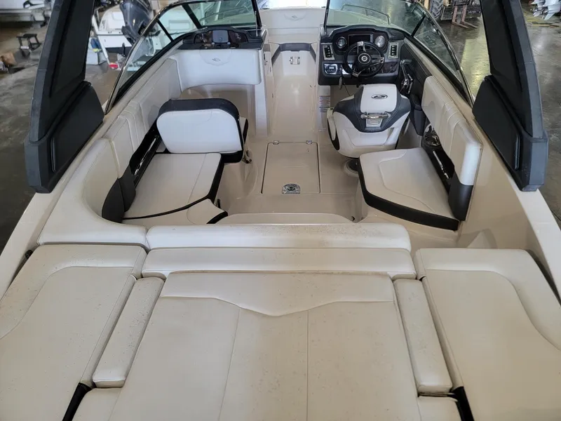 Slide: The Image of 2019 Chaparral 237 SSX boat interior with white seating and modern dashboard. - 5