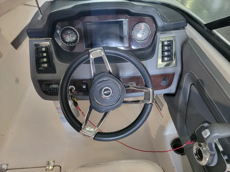 Slide: The Image of 2019 Chaparral 237 SSX boat dashboard with steering wheel and controls. - 9