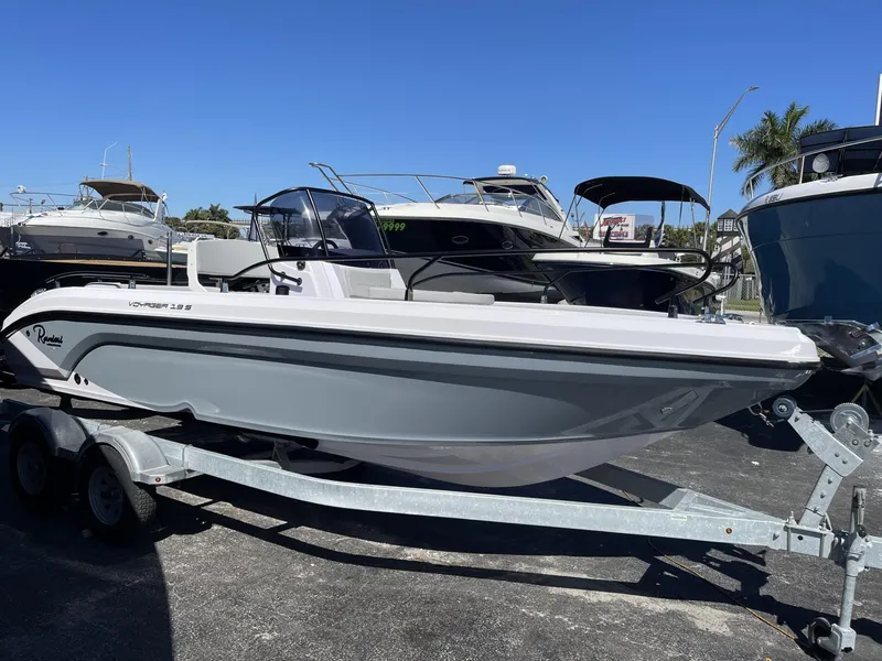 Slide: The Image of 2024 Ranieri Voyager 19S boat on trailer, featuring a Mercury outboard motor. - 0