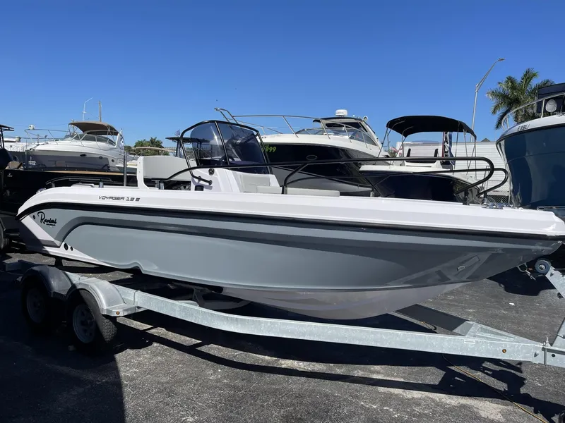 Slide: The Image of 2024 Ranieri Voyager 19S boat with white seating and a patterned table on deck. - 13