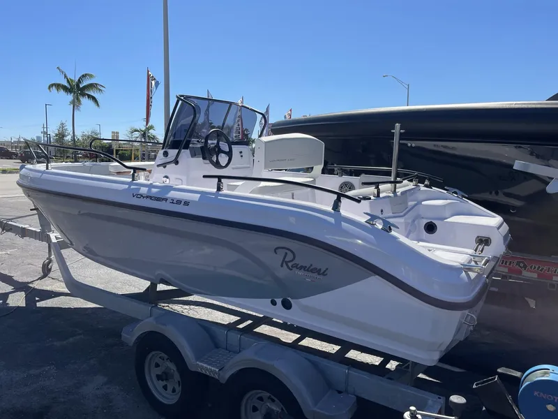 Slide: The Image of 2024 Ranieri Voyager 19S boat on trailer under clear blue sky. - 16
