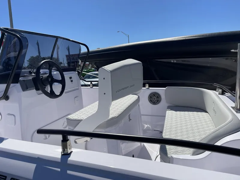 Slide: The Image of 2024 Ranieri Voyager 19S boat on trailer, parked outdoors under clear blue sky. - 17