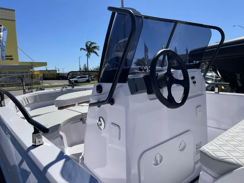 Slide: The Image of 2024 Ranieri Voyager 19S boat interior with steering wheel and seating. - 18