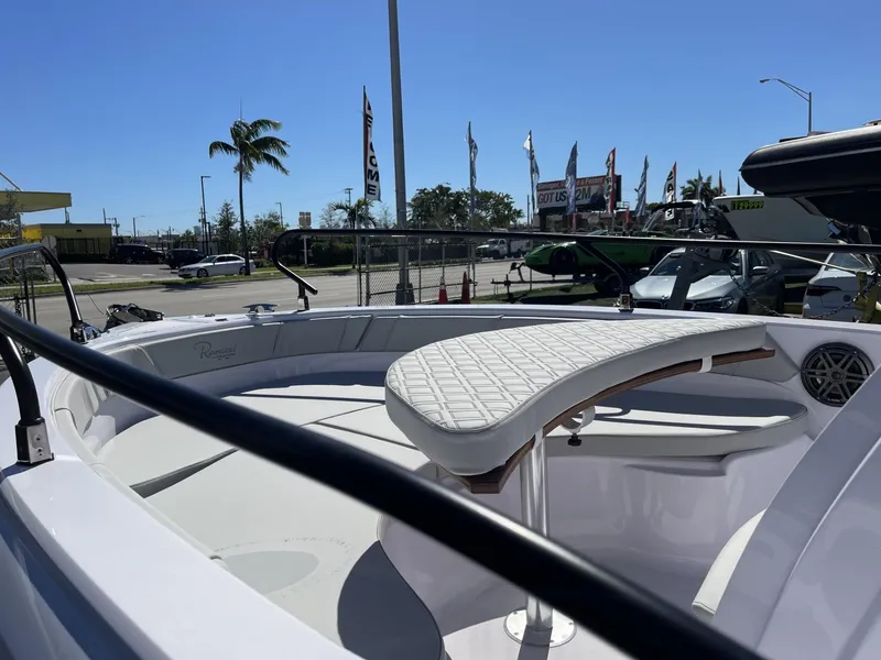 Slide: The Image of 2024 Ranieri Voyager 19S boat interior with white seating and steering wheel. - 20