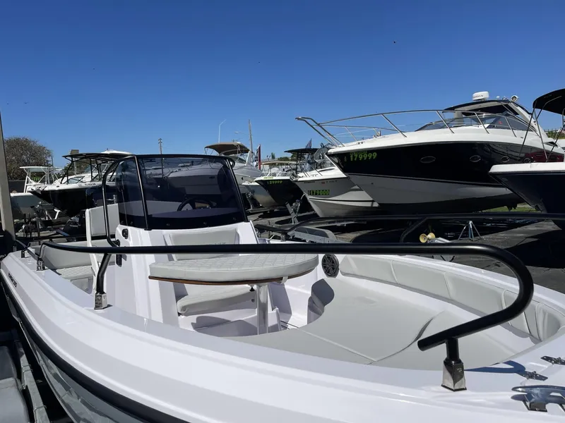 Slide: The Image of 2024 Ranieri Voyager 19S boat with sleek seating, displayed outdoors under clear blue sky. - 21