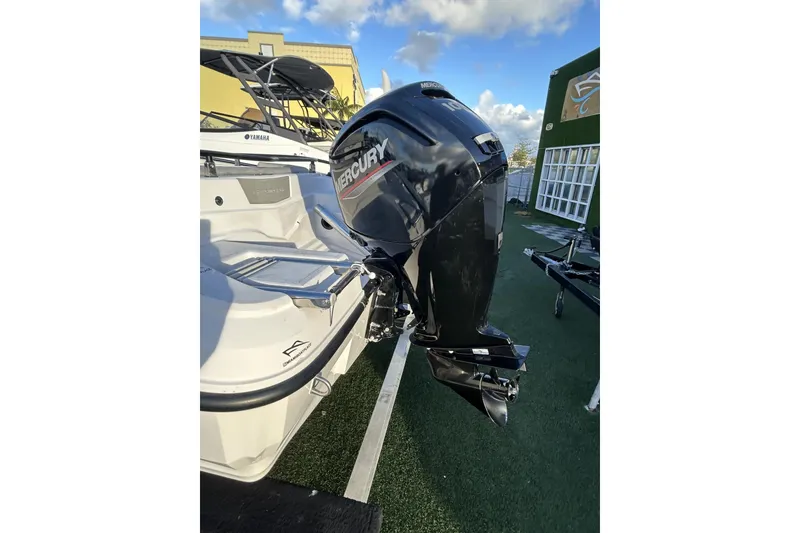 Slide: The Image of 2024 Ranieri Voyager 19S with Mercury outboard motor, displayed outdoors. - 27