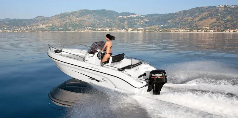 Slide: The Image of 2024 Ranieri Voyager 19S boat on water near rocky shore. - 4