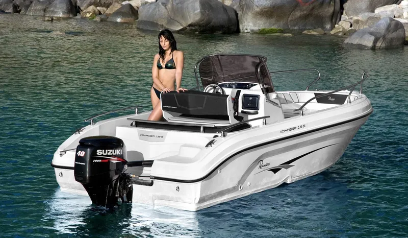 Slide: The Image of 2024 Ranieri Voyager 19S boat on clear blue water with a person onboard. - 7