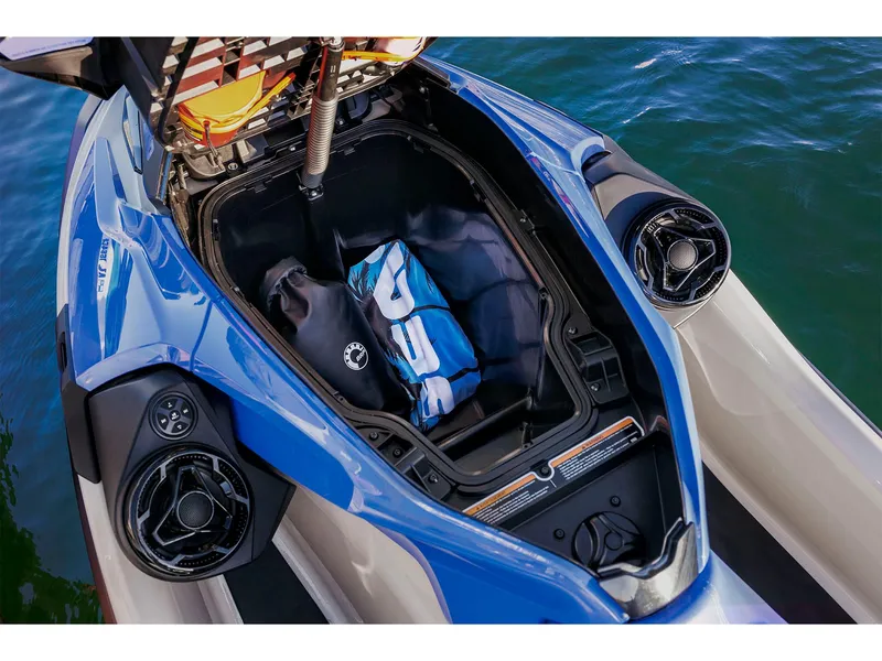 Slide: The Image of 2025 Sea-Doo Wake Pro 230 storage compartment with gear, on water. - 7