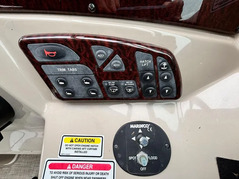Slide: The Image of Control panel of a 2006 Sea Ray 290 Sundancer boat with various switches and warnings. - 14